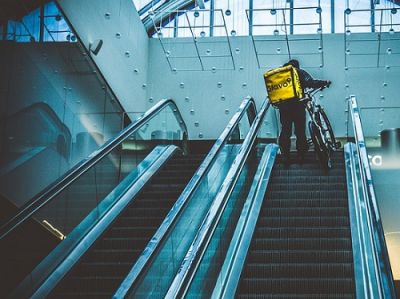 delivery rider on escalator