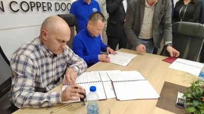 Men signing agreement