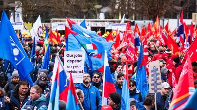 Sign reading "our jobs depend on your decisions" at an industriAll Europe rally in Brussels.