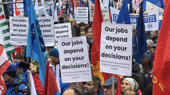Placard reads "our jobs depend on your decisions" during industrial workers demonstration in Brussels