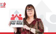 ETUC Deputy General Secretary Esther Lynch holding a sign saying: Europe needs a pay rise